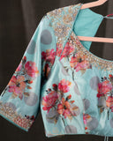 Rust Organza saree paired with a floral blouse