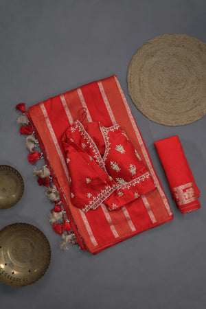 A striking red Mashru silk saree with a designer blouse