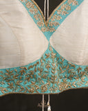 A contemporary lace saree in pastel blue with a stunning blouse pattern