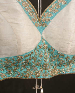 A contemporary lace saree in pastel blue with a stunning blouse pattern