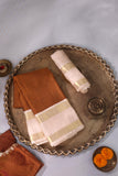 A beautiful vintage kanjeevaram in coppery rust with an ivory border