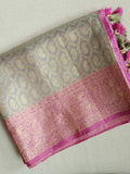 Kanjeevaram in a beautiful shade of gray with a contrast pink border.