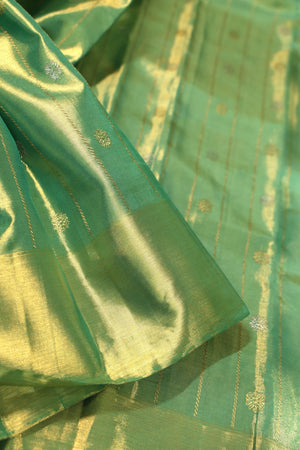Green Tissue Kanchi saree with a contrast off white blouse