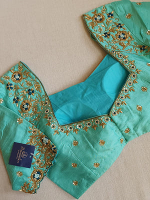 Peacock Green with aqua blue rawsilk saree with a stylish blouse
