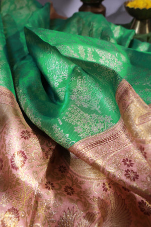 Green Kanjeevaram saree with a peach pink border