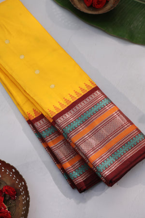 Radiant yellow Kanchipattu saree with maroon border