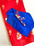 Red organza saree with a contrast blue work blouse