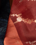 Rust Organza saree paired with a floral blouse