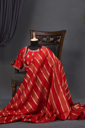 A striking red Mashru silk saree with a designer blouse