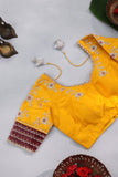 Radiant yellow Kanchipattu saree with maroon border