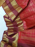 A stunning vintage kanjeevaram in rust orange with a deep maroon border