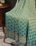 A Bandini Georgette saree in hues of blue paired with a blue pearl work blouse