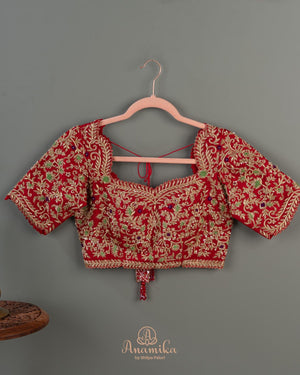 Red Banarasi saree with a heavy bridal zardosi work blouse