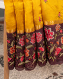 Yellow pure silk saree with contrast brown floral cutwork border