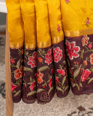 Yellow pure silk saree with contrast brown floral cutwork border