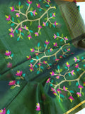 Bottle Green Jamdaani saree paired with a contrast yellow paithani blouse