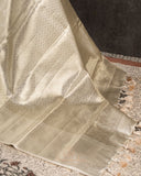 Cream kanjeevaram saree with a mono tone pearl work blouse