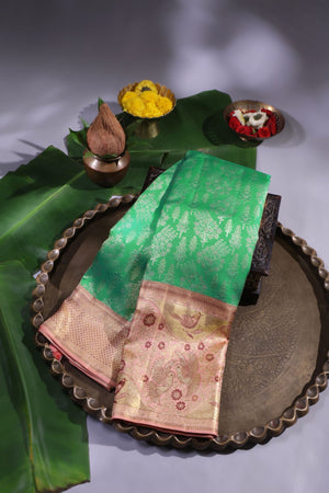 Green Kanjeevaram saree with a peach pink border