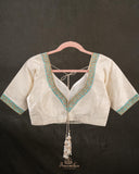 A contemporary lace saree in pastel blue with a stunning blouse pattern