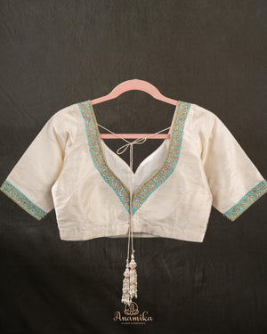 A contemporary lace saree in pastel blue with a stunning blouse pattern