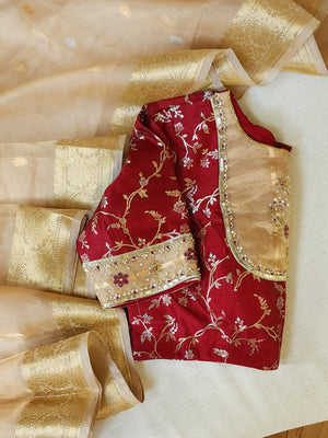 Banarasi Gold Tissue saree paired with a contrast maroon blouse