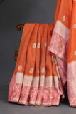 An exquisite Silk Saree in burnt orange and rose pink