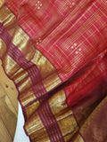 A stunning vintage kanjeevaram in rust orange with a deep maroon border