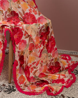 Beige Floral Chinnon saree with a contrast tomato pink handwork blouse