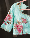 A beautiful Floral blouse in pastel blue with intricately designed embroidery