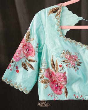 A beautiful Floral blouse in pastel blue with intricately designed embroidery