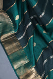 A lovely organza saree in shaded dark green with a red designer blouse