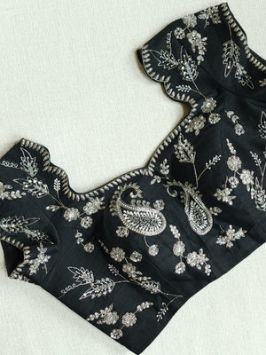 A pure crepe saree in black with stunning silver embroidered border