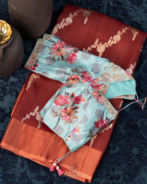 Rust Organza saree paired with a floral blouse
