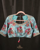 A beautiful Floral blouse in pastel blue with intricately designed embroidery