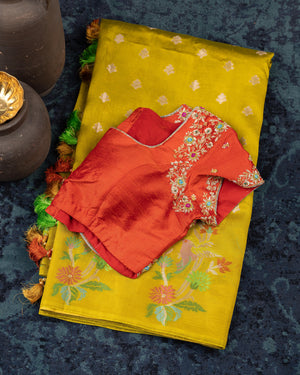 Mustard yellow organza saree with a contrast orange blouse