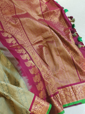 A Royal Gadwal kanchi saree in sage green with rich magenta border