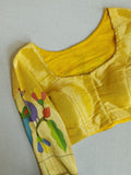 Bottle Green Jamdaani saree paired with a contrast yellow paithani blouse