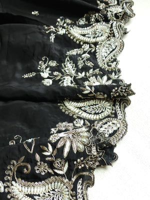 A pure crepe saree in black with stunning silver embroidered border