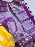 Venkatagiri Pattu saree in yellow with a contrast purple blouse