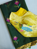 Bottle Green Jamdaani saree paired with a contrast yellow paithani blouse