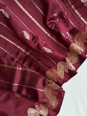 Raw  mango Pattu saree in maroon paired with a contrast mauve lilac blouse