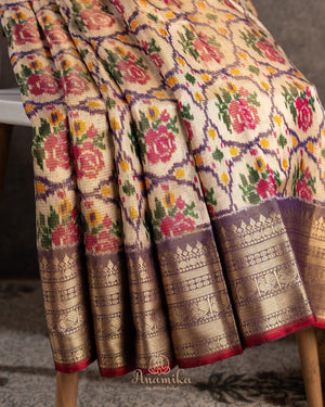 Light brown twill Patola saree with a contrast lavender border