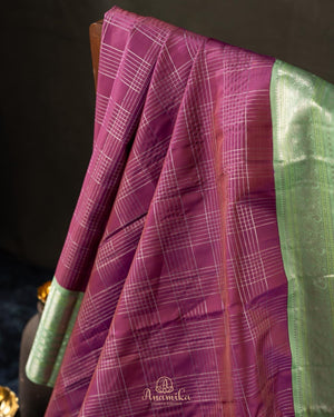 A kanjeevaram saree in purple with pastel green combo
