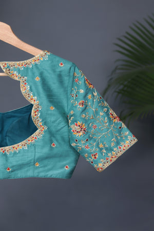 A classic patola in aqua blue with a striking contrast red