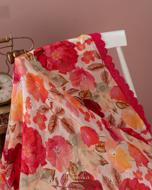 Beige Floral Chinnon saree with a contrast tomato pink handwork blouse