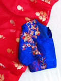 Red organza saree with a contrast blue work blouse