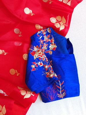 Red organza saree with a contrast blue work blouse
