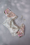 A beautiful rose pink tissue saree with an off white blouse