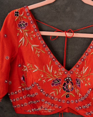 Orange Elbow sleeves blouse with intricately designed gold and black thread work