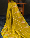 Mustard yellow organza saree with a contrast orange blouse